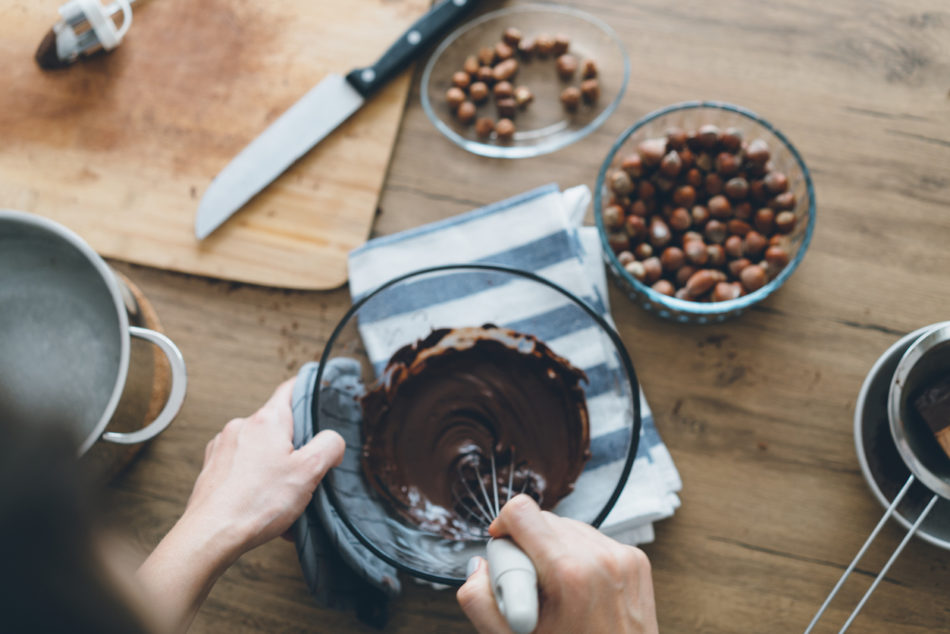 Woman mixing melted chocolate in a bowl
