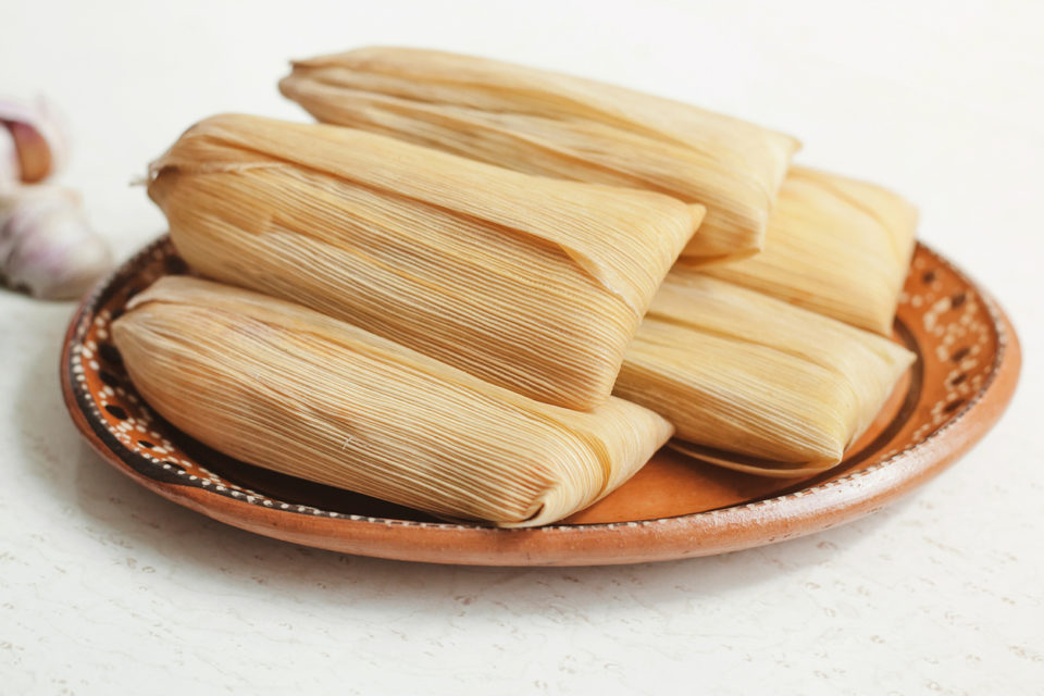 a plate of stacked tamales