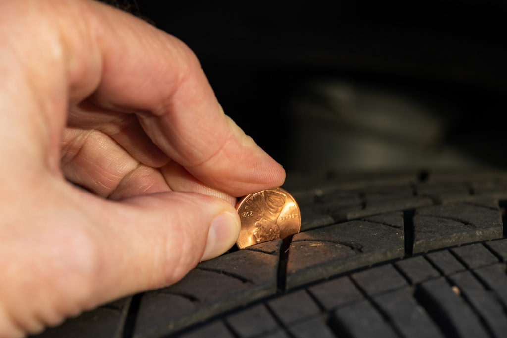 Using a penny to check tread depth on a tire