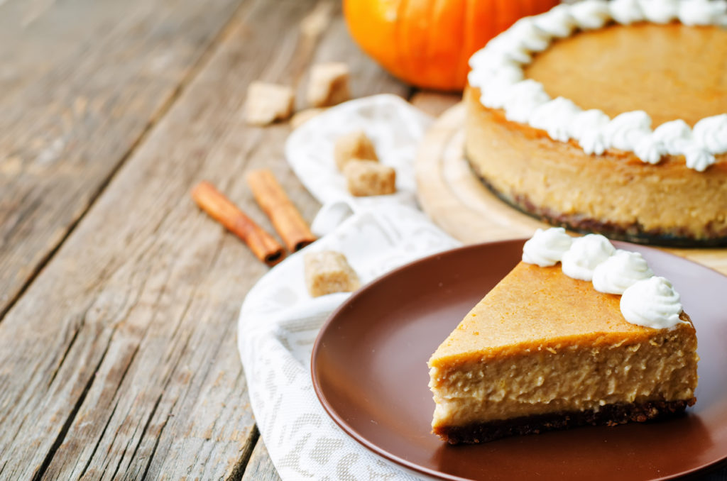pumpkin cheesecake decorated with whipped cream