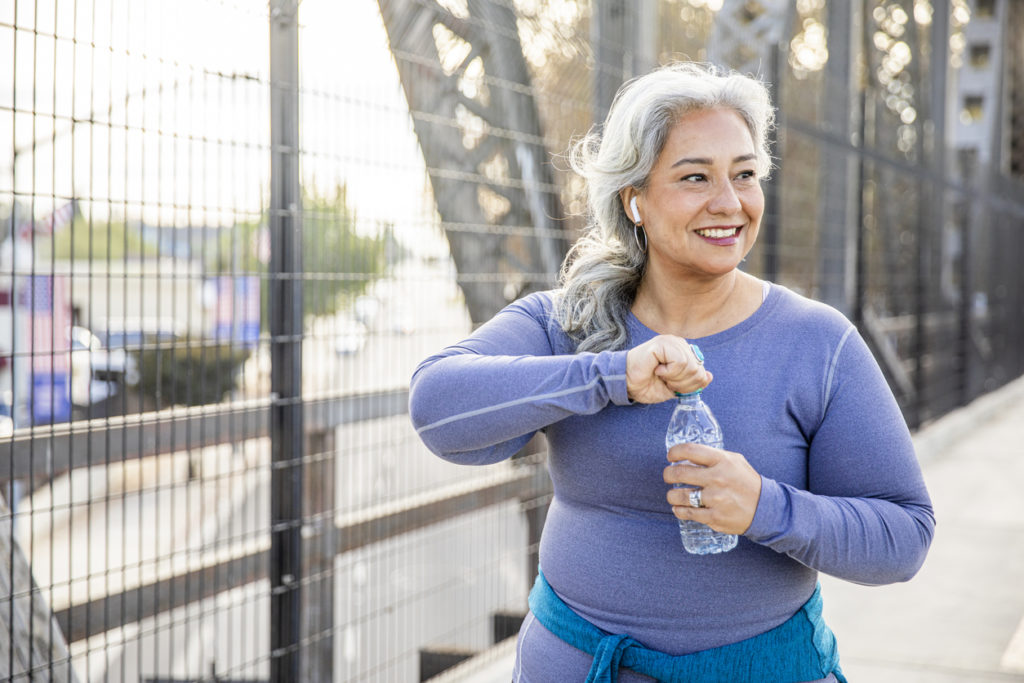A woman drinking water after a workout